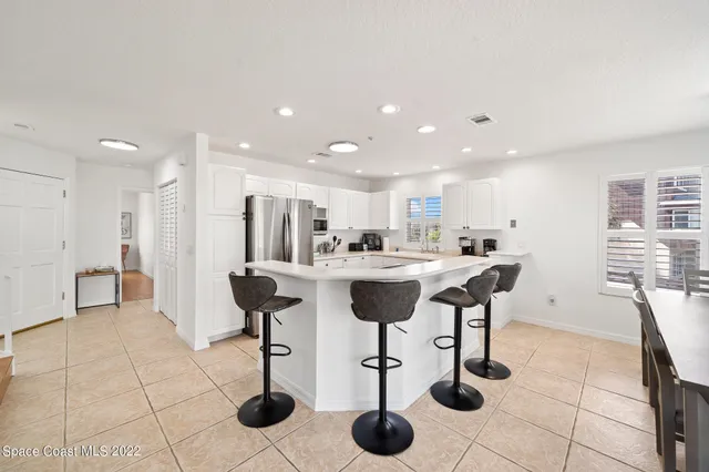 a kitchen that has a sink and a stove with white countertops