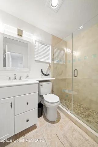 a view of a hallway with wooden floor and a livingroom view