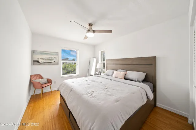 a bedroom with a bed and a painting on the wall