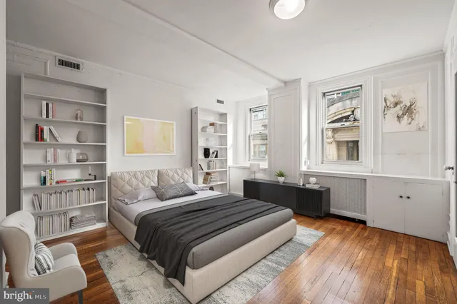 a bedroom with a large bed and a window