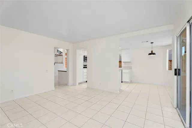 a kitchen with stainless steel appliances a stove a sink a microwave a refrigerator and cabinets