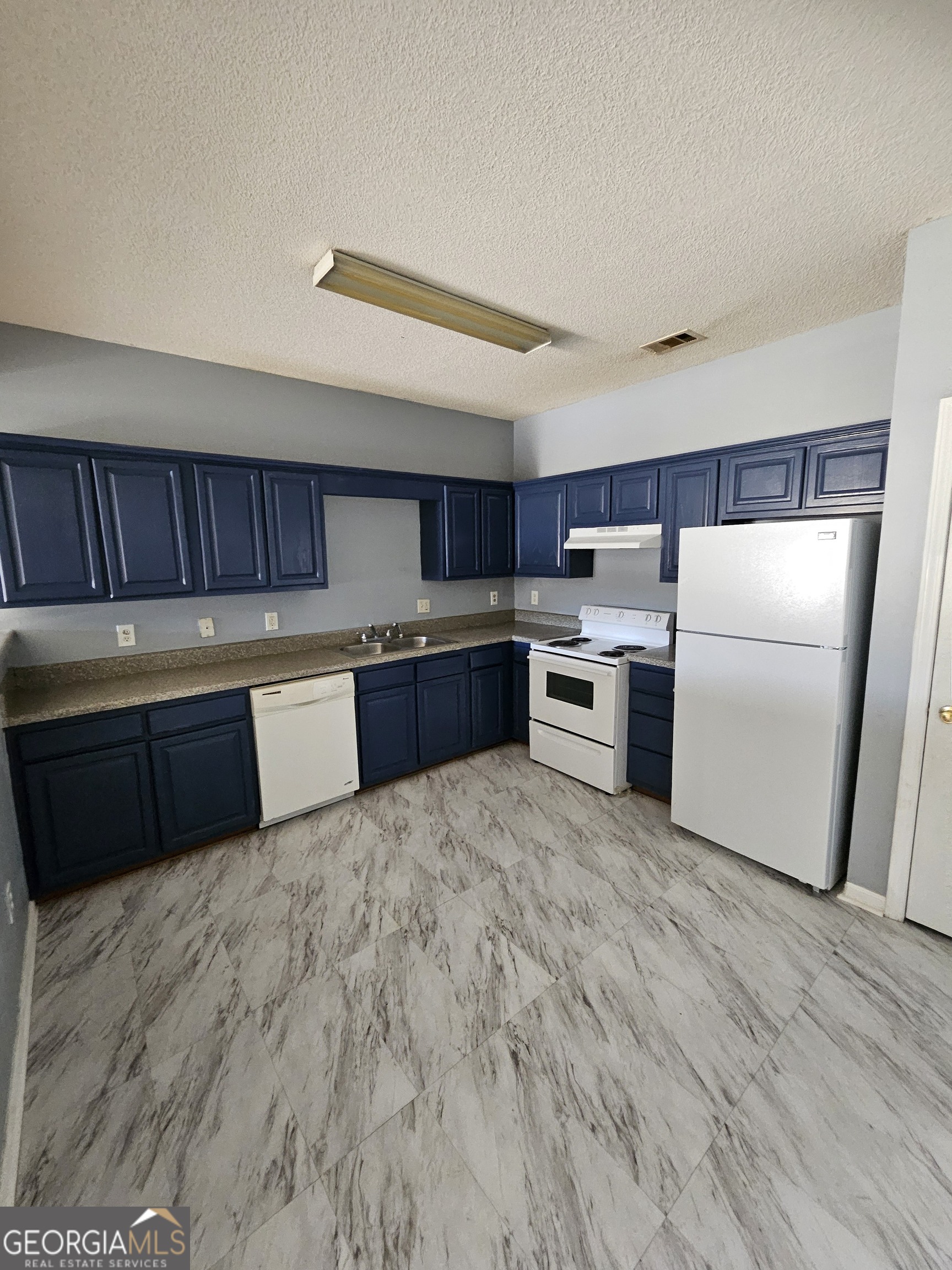 1467 Riverrock Trail Southwest Riverdale, GA 30296 - Photo 2 of 8 a kitchen with a cabinets and wooden floor