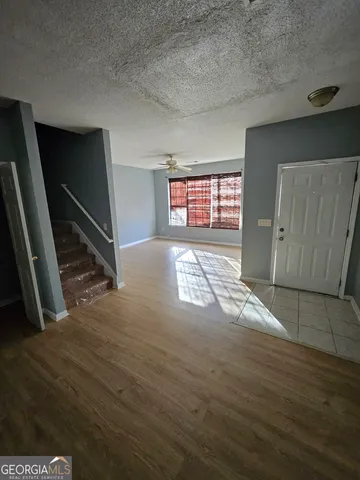 a view of empty room with window and stairs