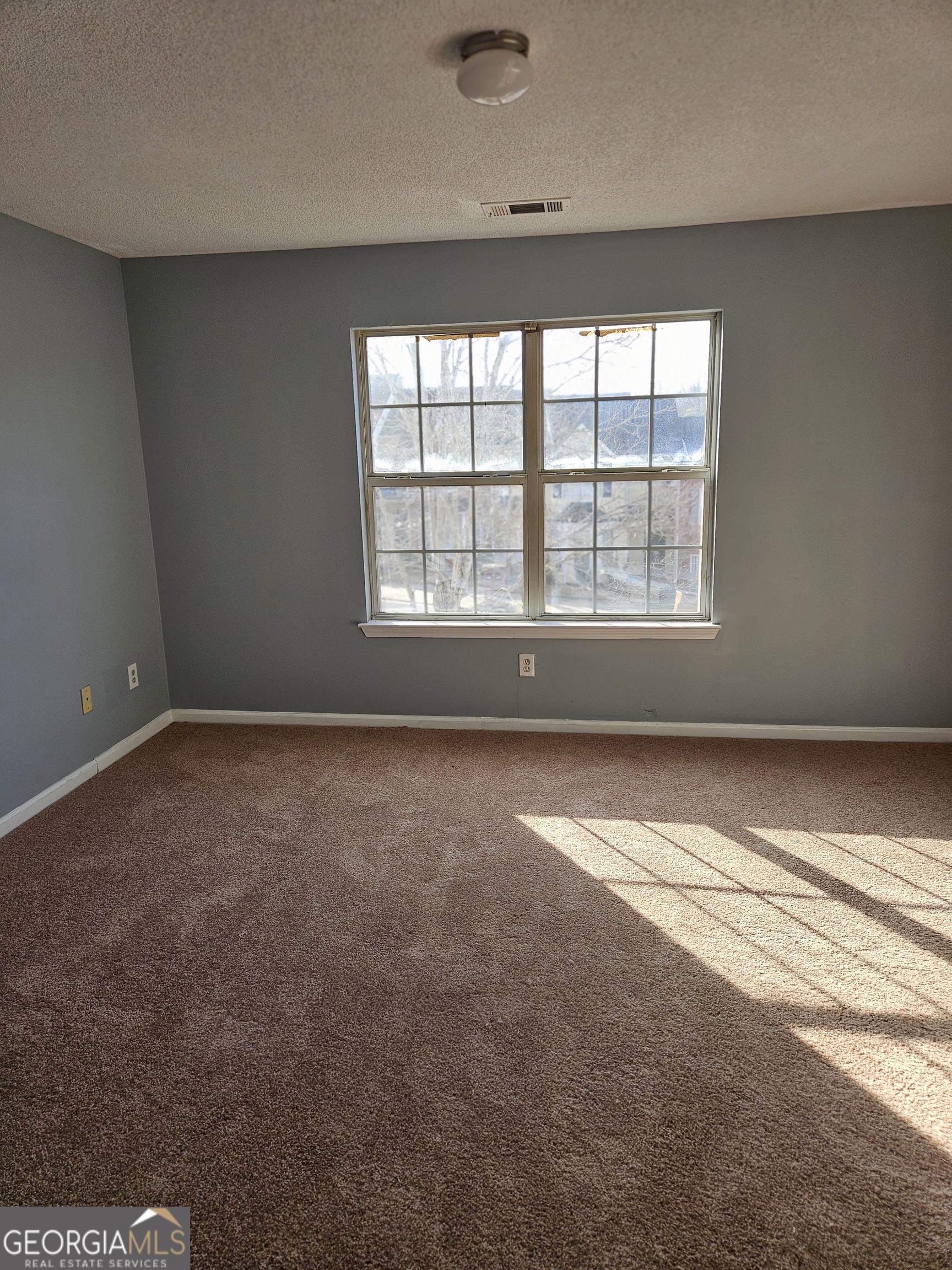 1467 Riverrock Trail Southwest Riverdale, GA 30296 - Photo 7 of 8 an empty room with a empty space and windows