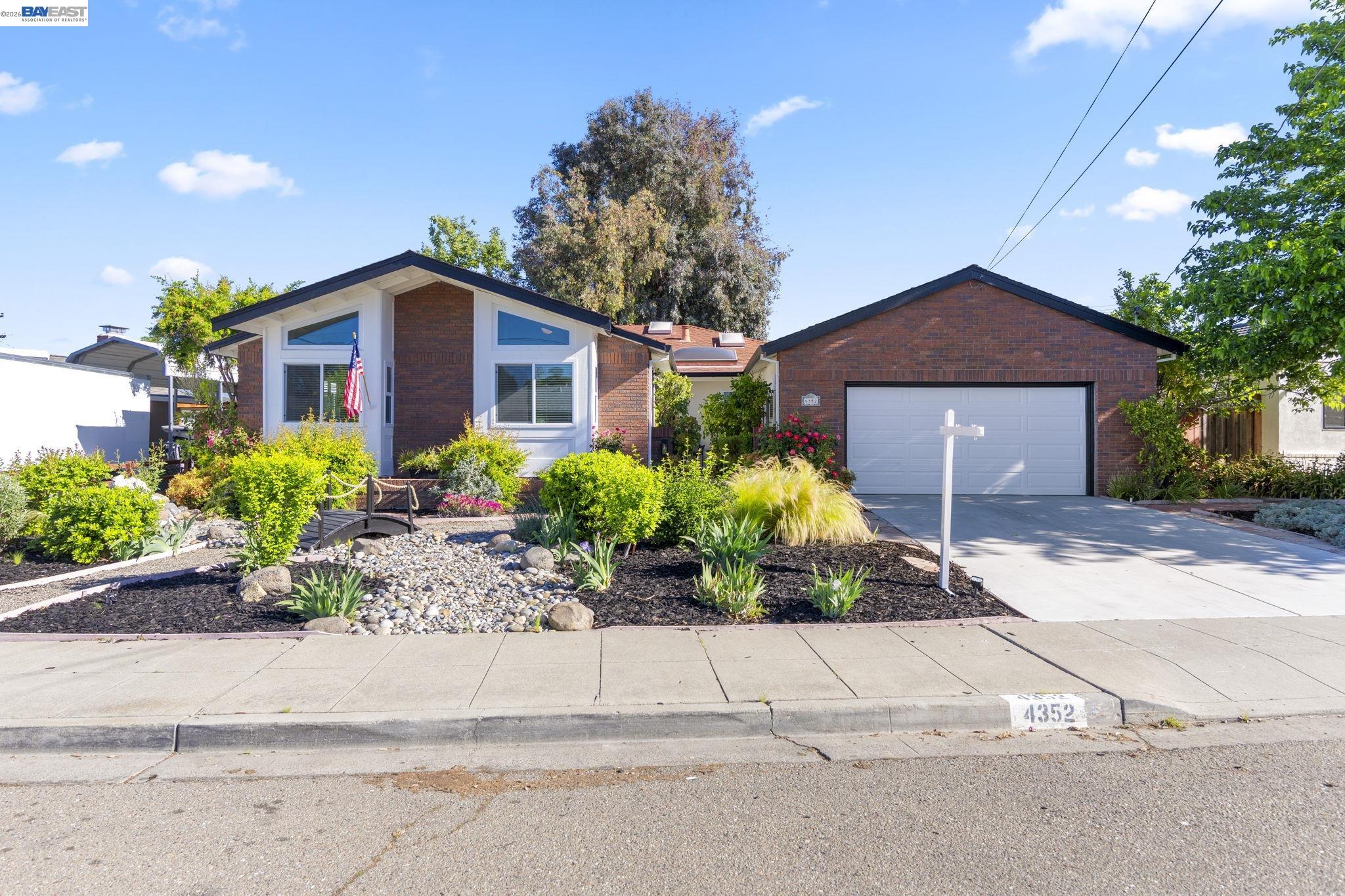 4352 Davis Way Livermore, CA 94550 - Photo 1 of 37 a front view of a house with a yard and potted plants