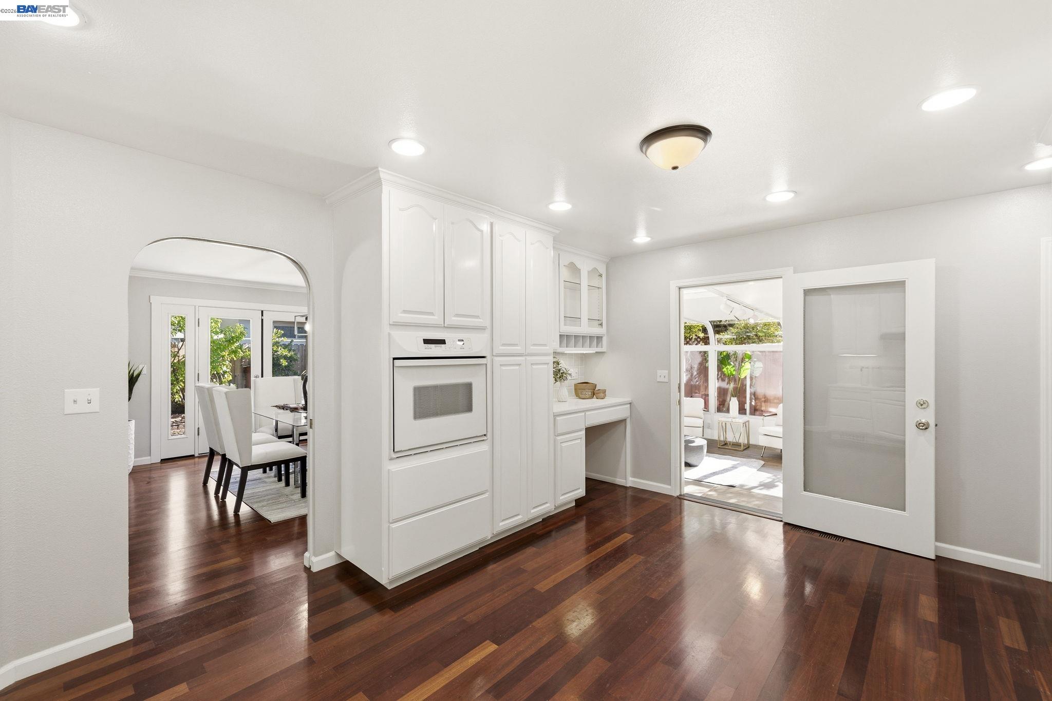 4352 Davis Way Livermore, CA 94550 - Photo 12 of 37 a kitchen with white cabinets and wooden floor