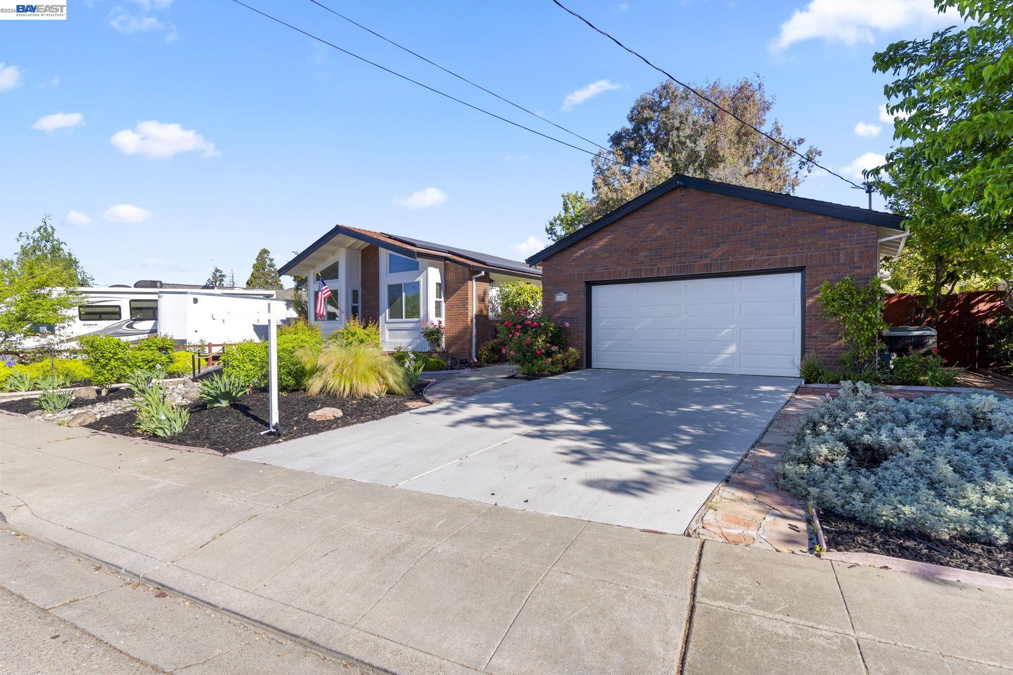 4352 Davis Way Livermore, CA 94550 - Photo 2 of 37 a front view of a house with a yard and potted plants