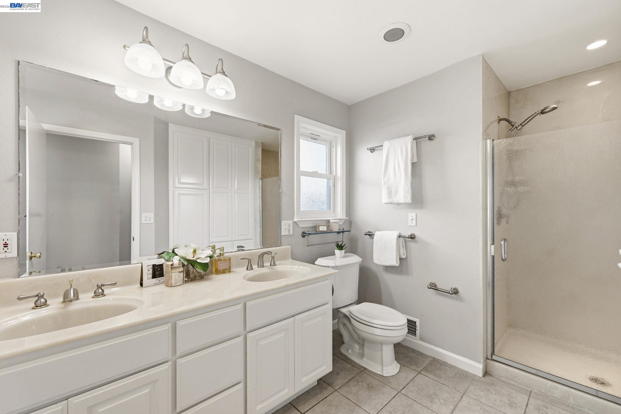 4352 Davis Way Livermore, CA 94550 - Photo 25 of 37 a bathroom with a double vanity sink mirror and toilet