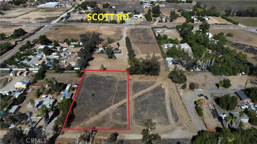 an aerial view of a house with a yard and lake view