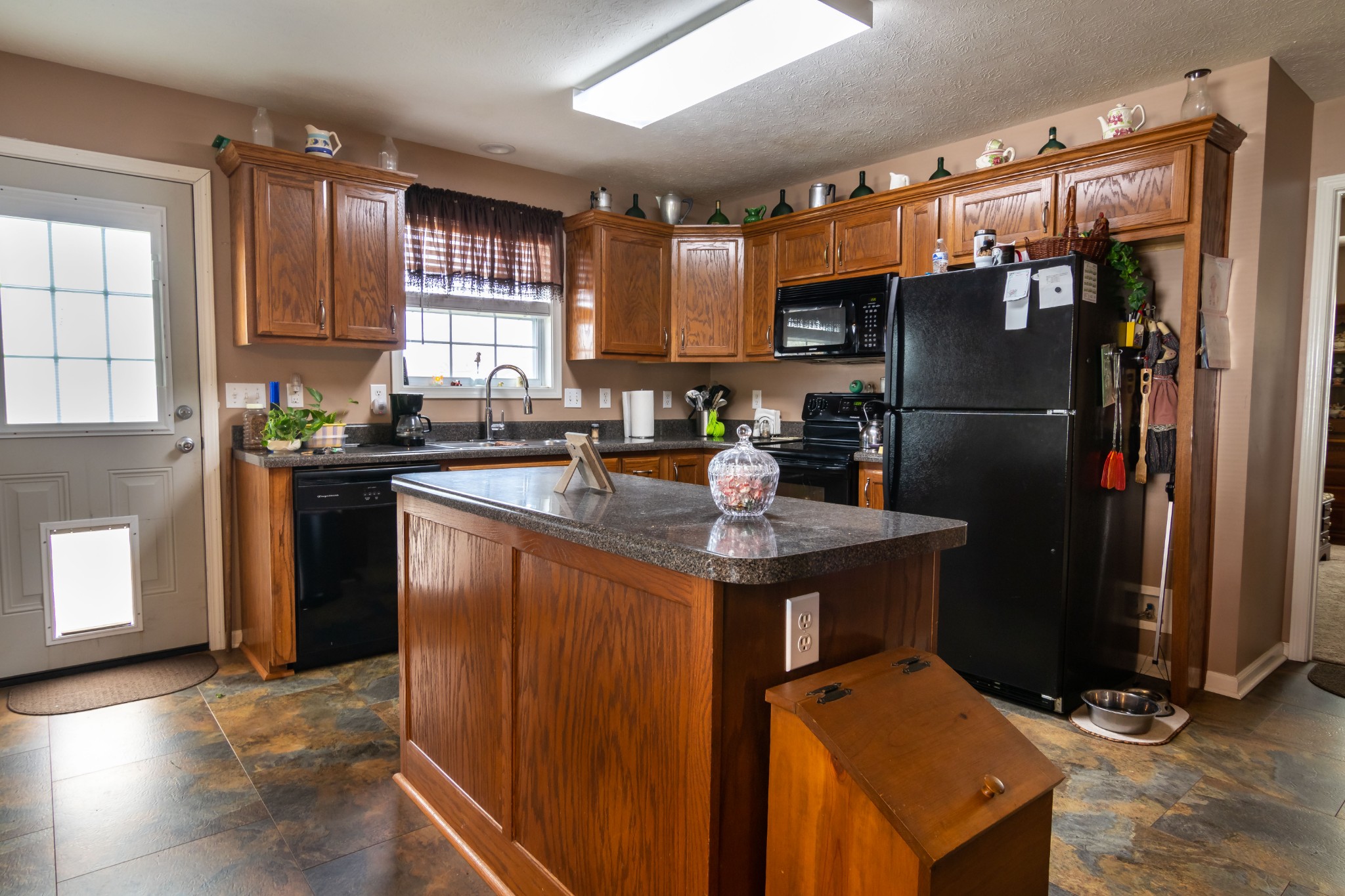 123 Filly Lane Springfield, TN 37172 - Photo 8 of 23 a kitchen with granite countertop a refrigerator a sink a stove and cabinets