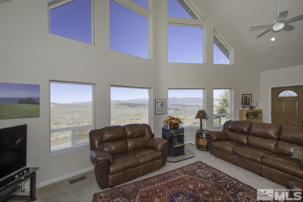 105 John Thomas Lane Reno, NV 89508 - Photo 4 of 25 a living room with furniture a flat screen tv and a fireplace