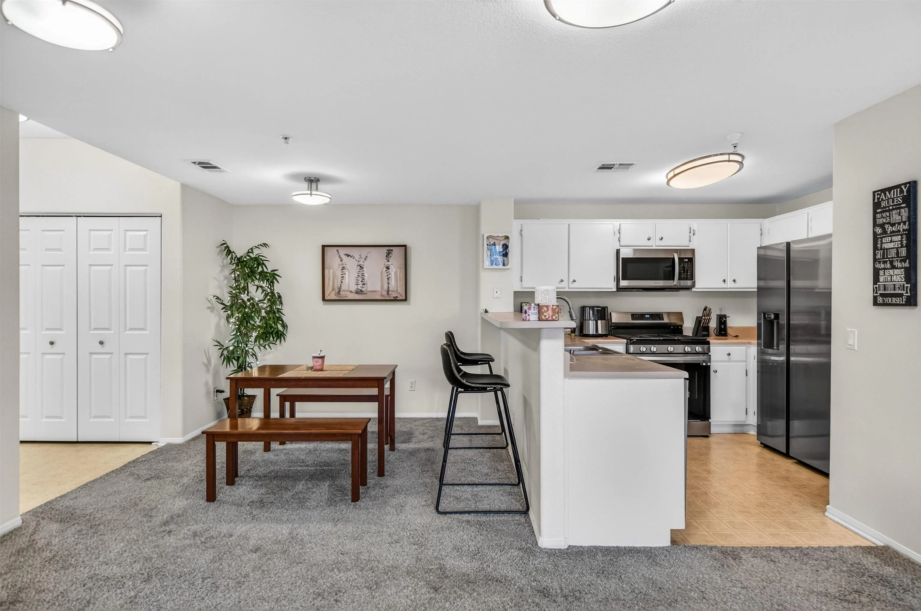 44706 Adam Lane Temecula, CA 92592 - Photo 12 of 36 a kitchen with stainless steel appliances kitchen island granite countertop a refrigerator and microwave