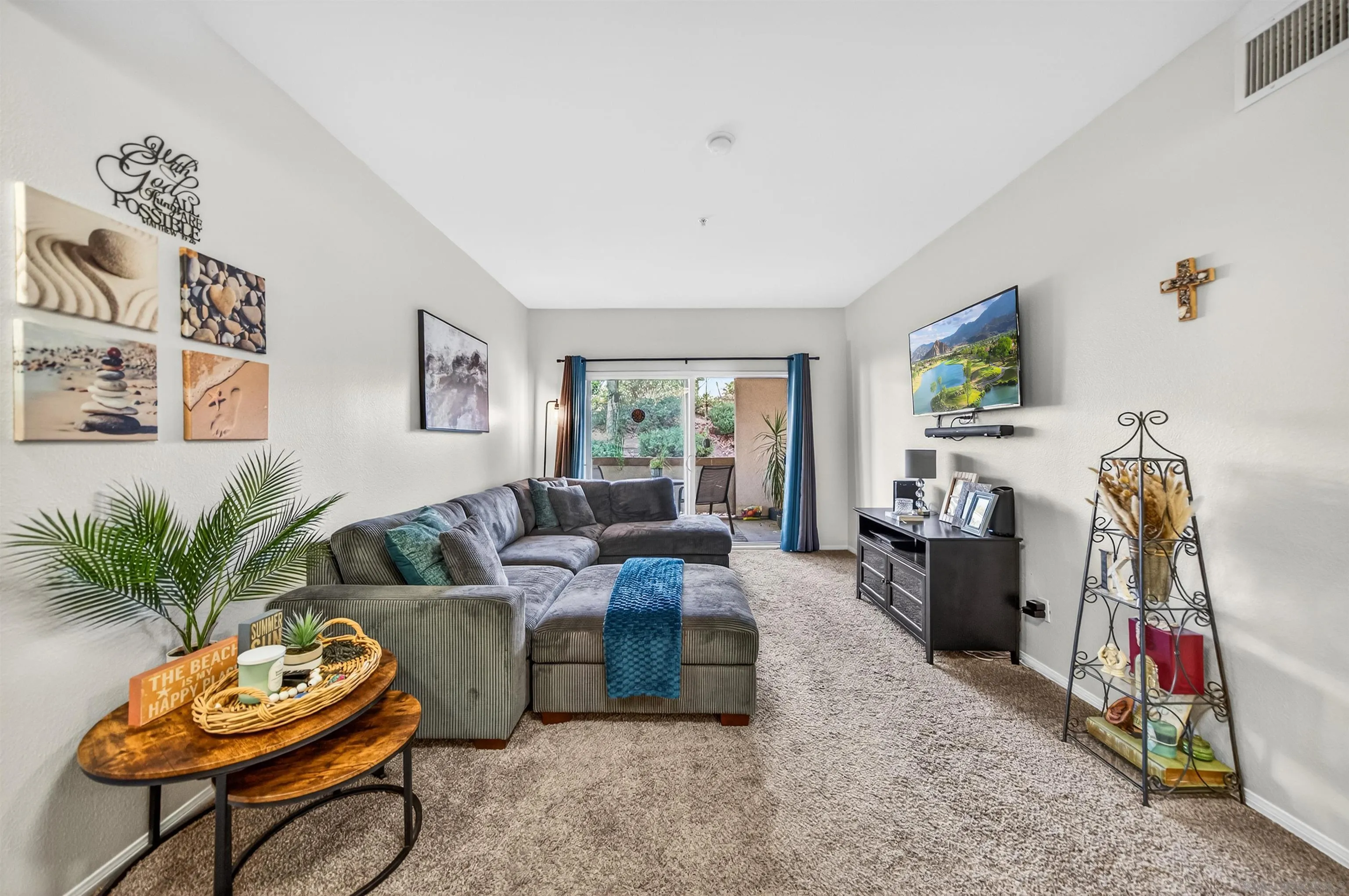 44706 Adam Lane Temecula, CA 92592 - Photo 16 of 36 a living room with furniture a flat screen tv and a large window