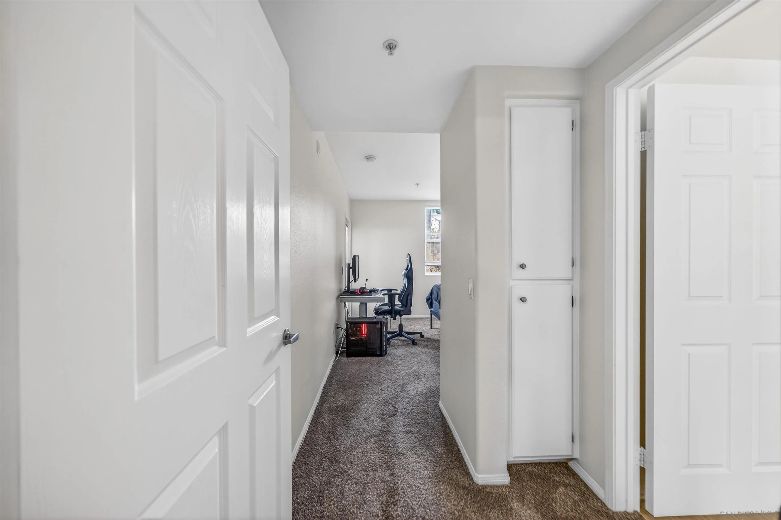 44706 Adam Lane Temecula, CA 92592 - Photo 25 of 36 a hallway with white doors wooden floor and furniture