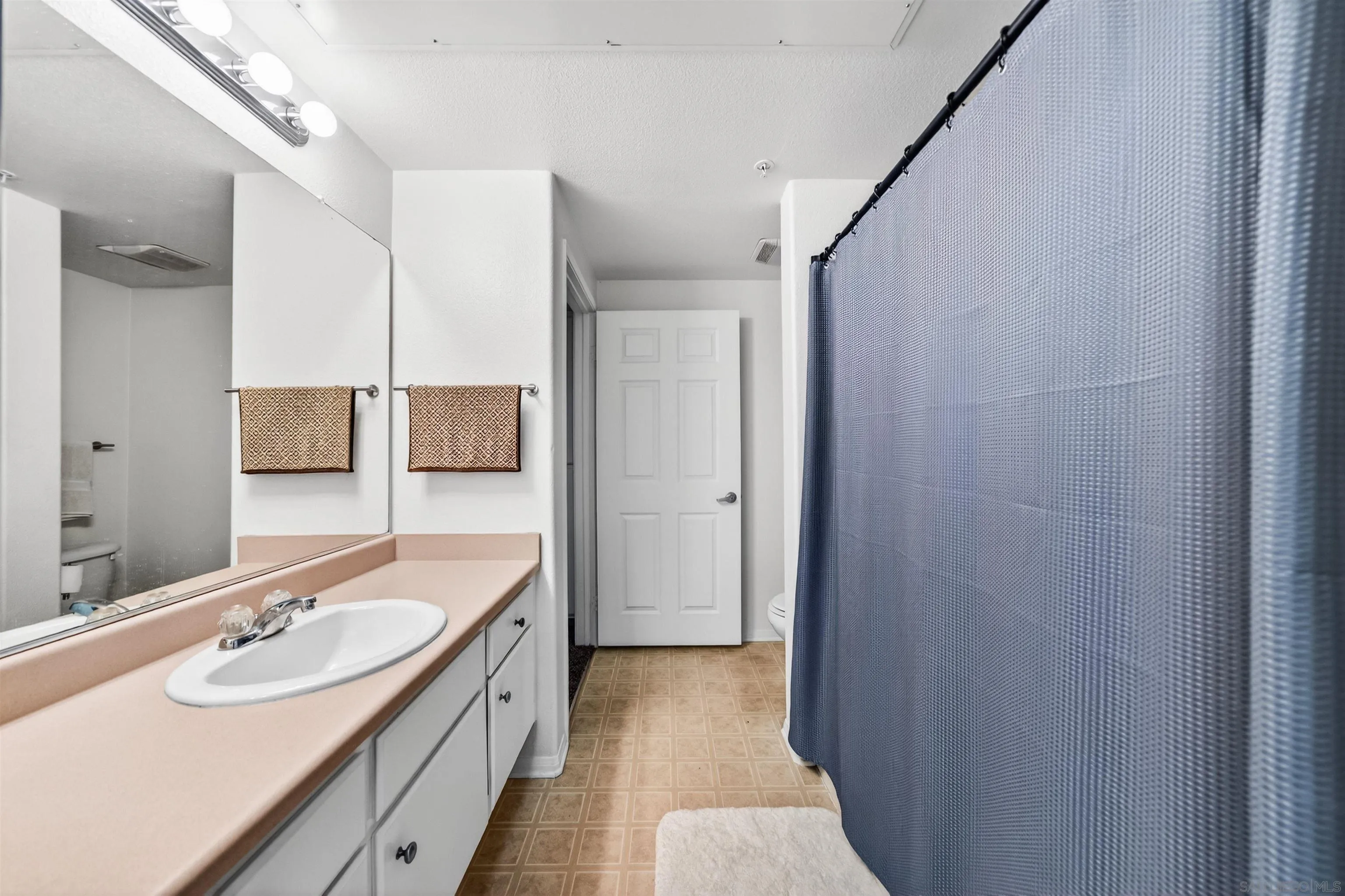 44706 Adam Lane Temecula, CA 92592 - Photo 28 of 36 a bathroom with a double vanity sink and mirror