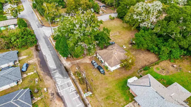 an aerial view of residential house with swimming pool and lawn chairs