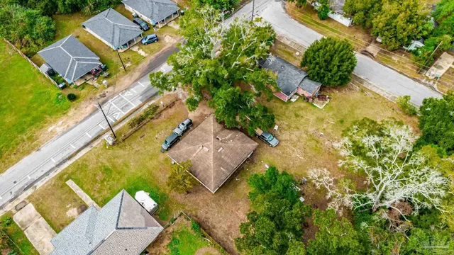 an aerial view of a house with a yard and swimming pool