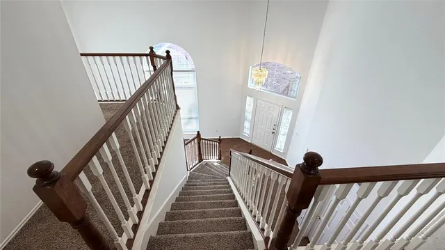 a view of staircase with railing and stairs