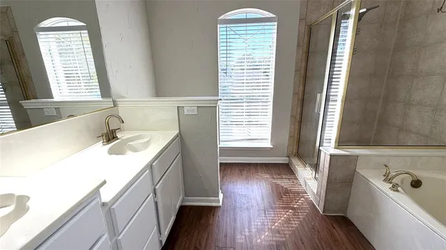 a bathroom with a sink a toilet a mirror and window