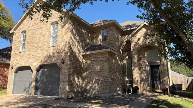 a view of a brick house with a large windows