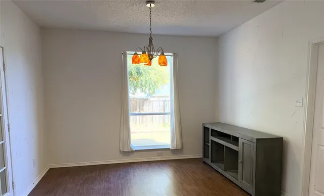 a kitchen with a stove and a wooden floor