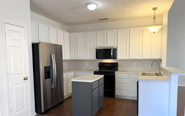 a kitchen with a refrigerator sink and microwave