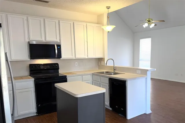 a kitchen with a sink and a stove