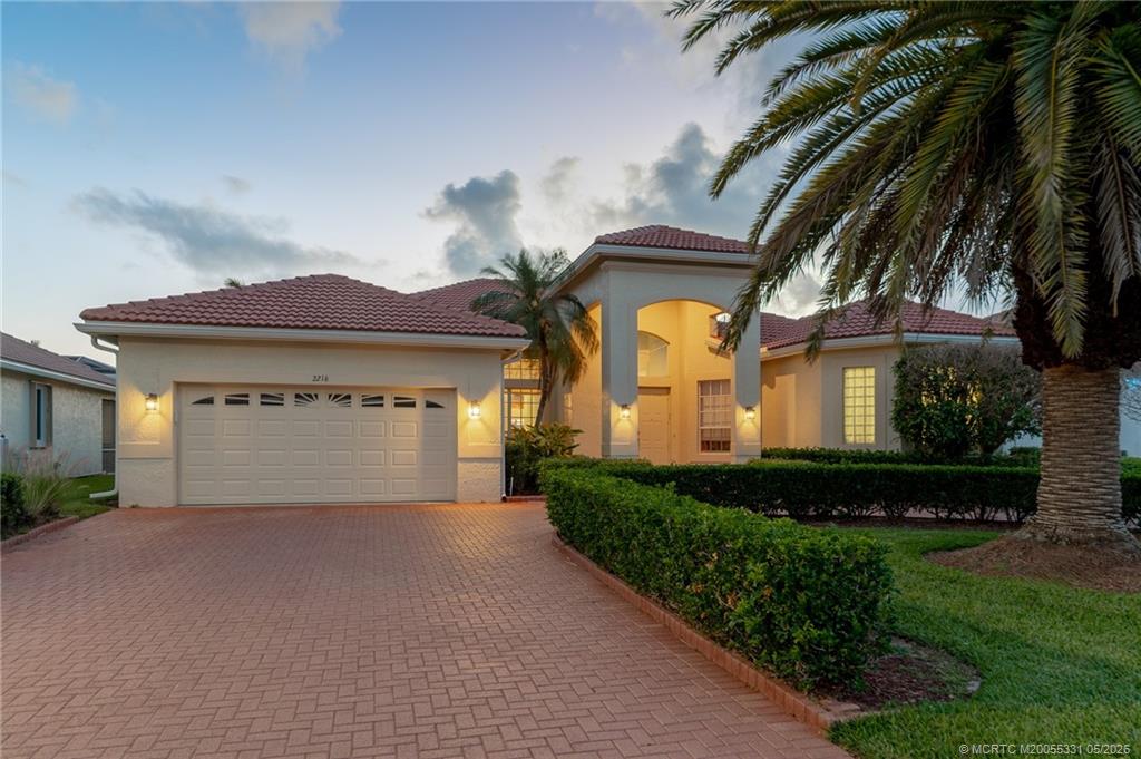 2216 Southeast Stonehaven Road Port St. Lucie, FL 34952 - Photo 3 of 67 a front view of a house with a garden