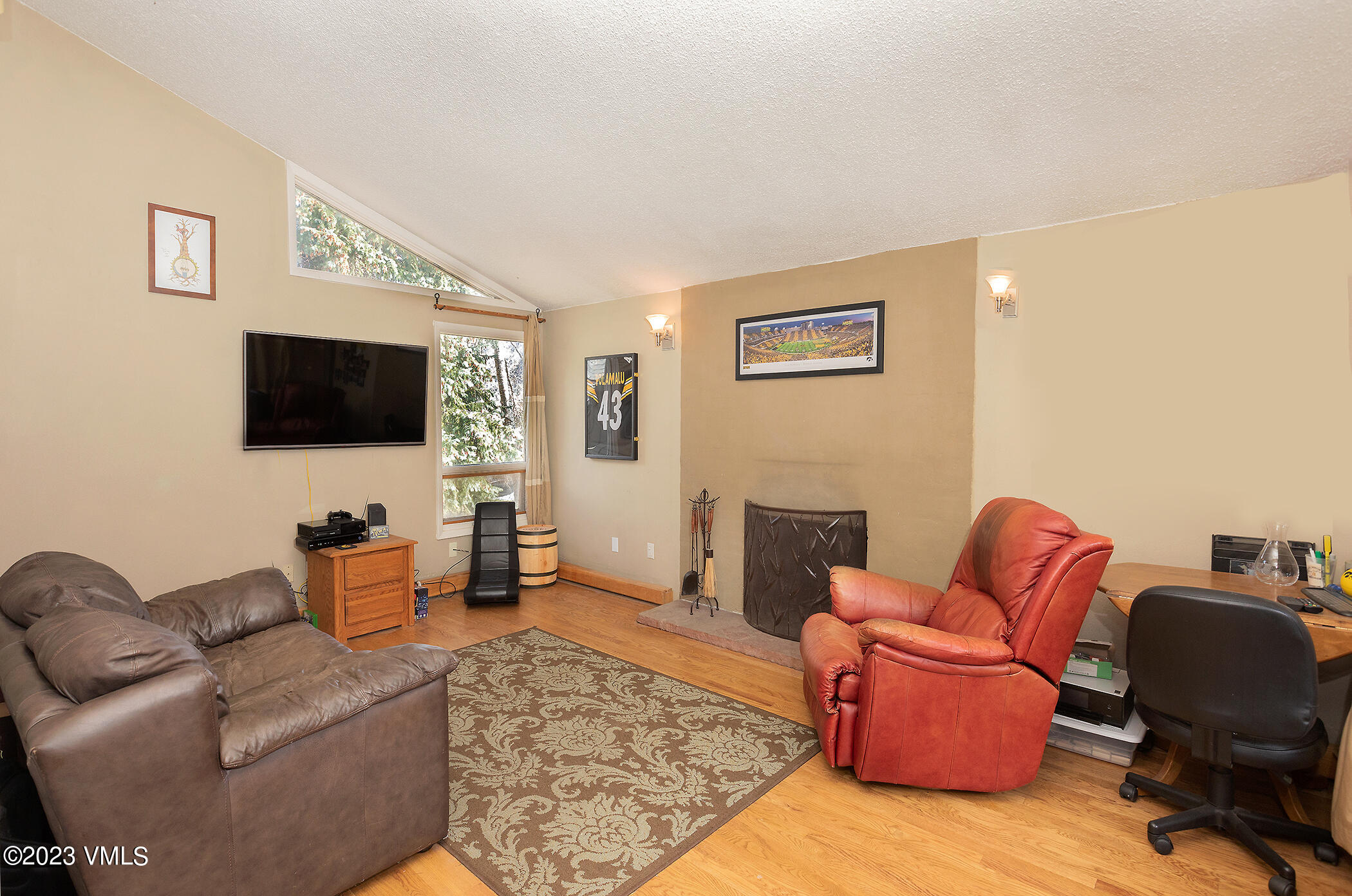 921 Red Sandstone Road, Unit D5 Vail, CO 81657 - Photo 2 of 16 a living room with furniture and a flat screen tv