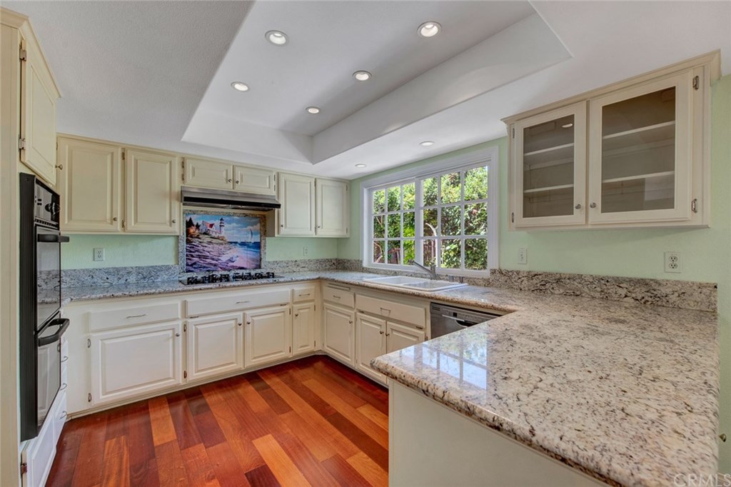 8 Bull Run Irvine, CA 92620 - Photo 17 of 52 Wood flooring, recessed lighting, white cabinetry, and granite counter tops