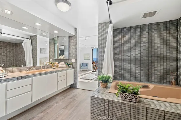 a bathroom with a granite countertop sink a toilet and shower