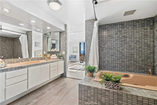 a bathroom with a granite countertop sink a toilet and shower