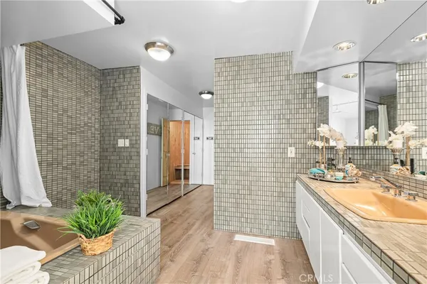 a bathroom with a granite countertop sink a toilet and shower