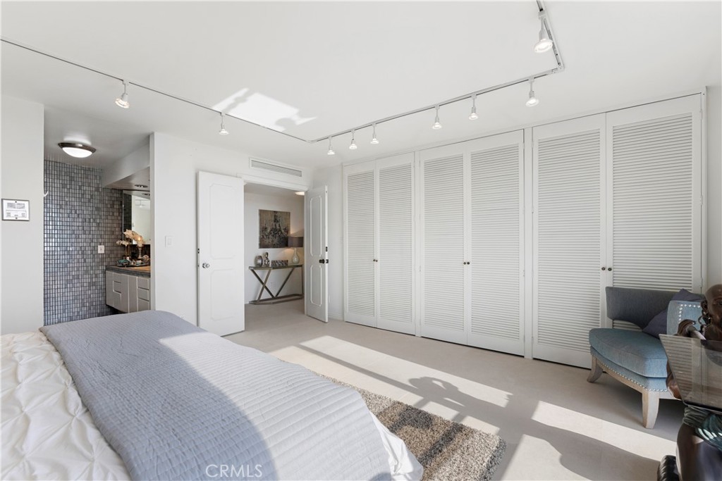 601 Lido Park Drive, Unit 6F Newport Beach, CA 92663 - Photo 15 of 28 a bedroom with a bed and furniture