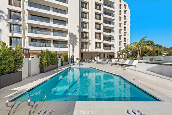 a swimming pool with outdoor seating and yard