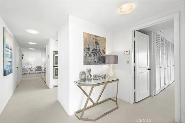 a view of a hallway with furniture and front door