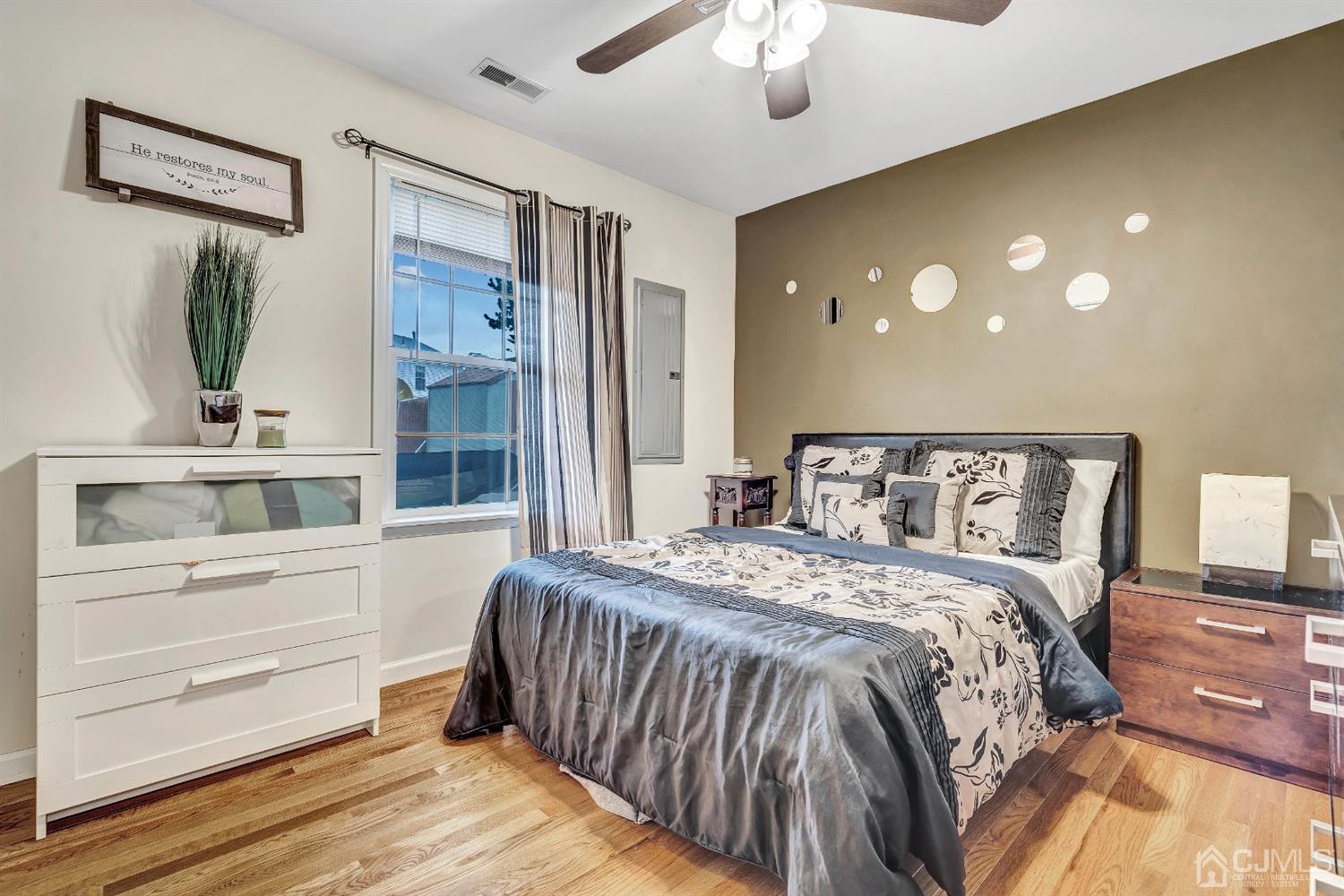 32 Comstock Road Edison, NJ 08817 - Photo 14 of 23 a bedroom with a large bed and a chandelier