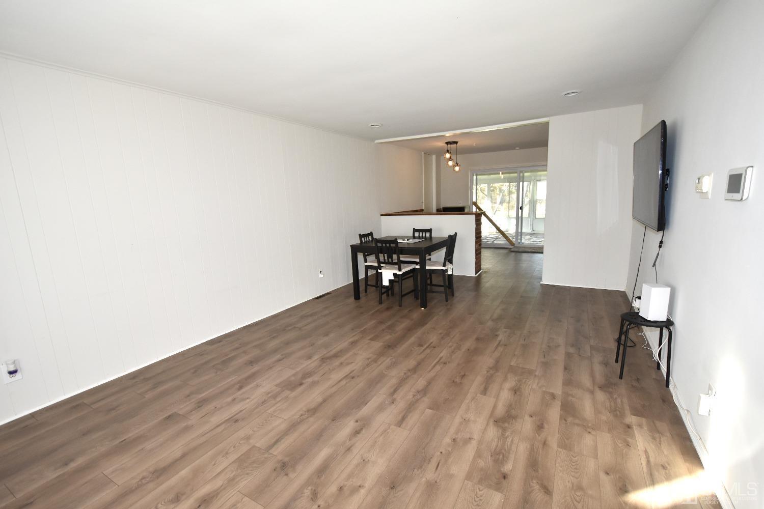 7 Calvin Road Kendall Park, NJ 08824 - Photo 3 of 28 a dining room with furniture and wooden floor