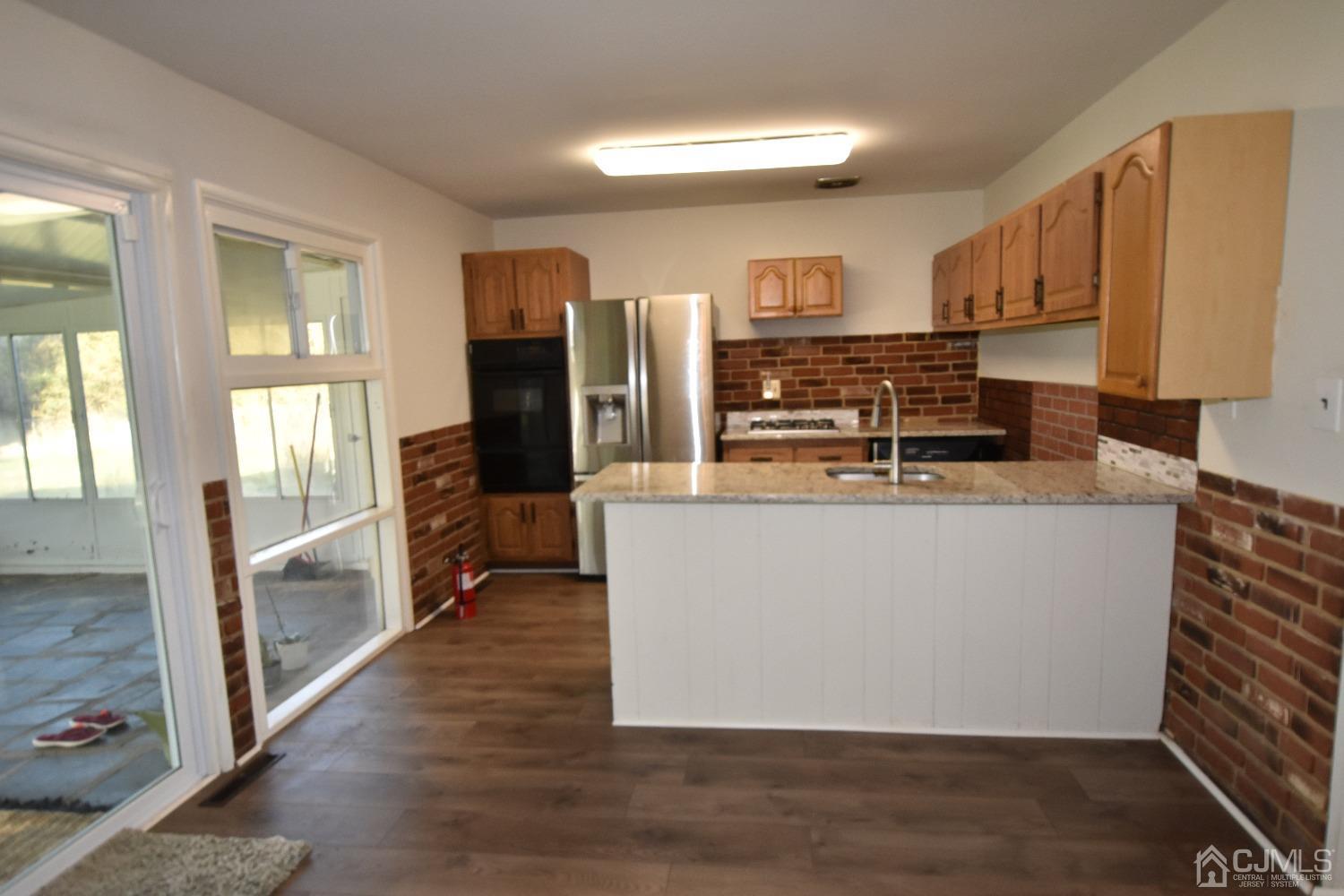 7 Calvin Road Kendall Park, NJ 08824 - Photo 8 of 28 a kitchen with stainless steel appliances granite countertop a refrigerator and a stove