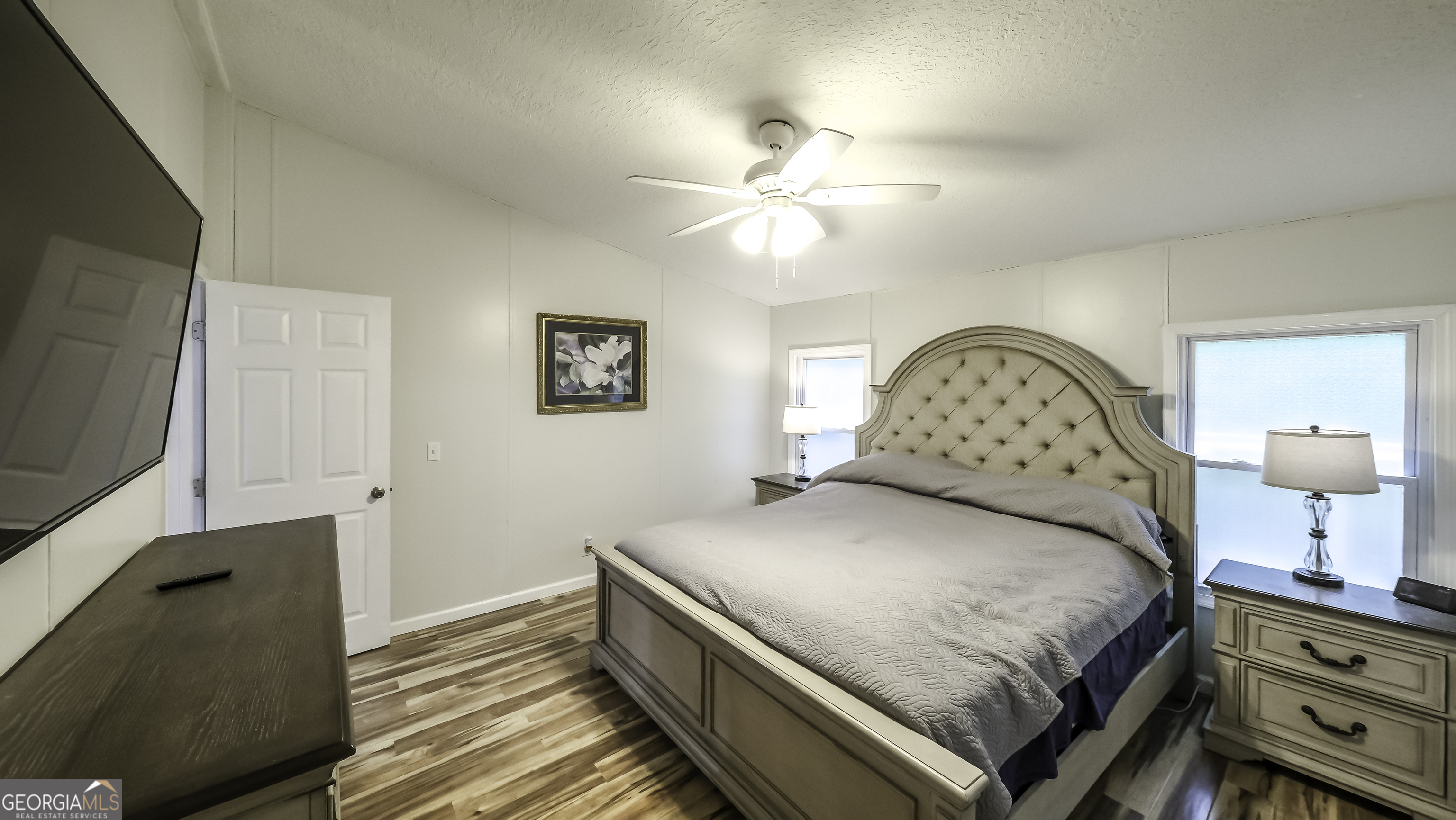 91 Holder Road Temple, GA 30179 - Photo 19 of 40 a bedroom with a bed and a chandelier