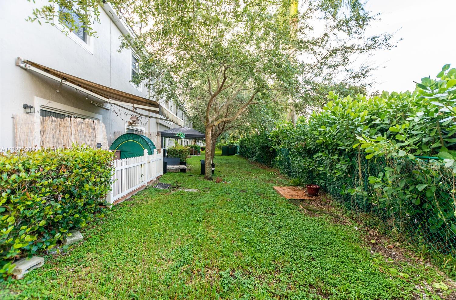 4979 Southwest 140th Terrace, Unit 8 Miramar, FL 33027 - Photo 13 of 43 a view of a small garden in front of a house