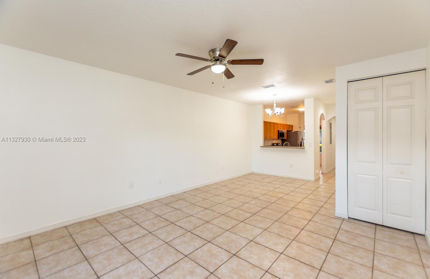 4979 Southwest 140th Terrace, Unit 8 Miramar, FL 33027 - Photo 16 of 43 a view of a livingroom with wooden floor and a ceiling fan