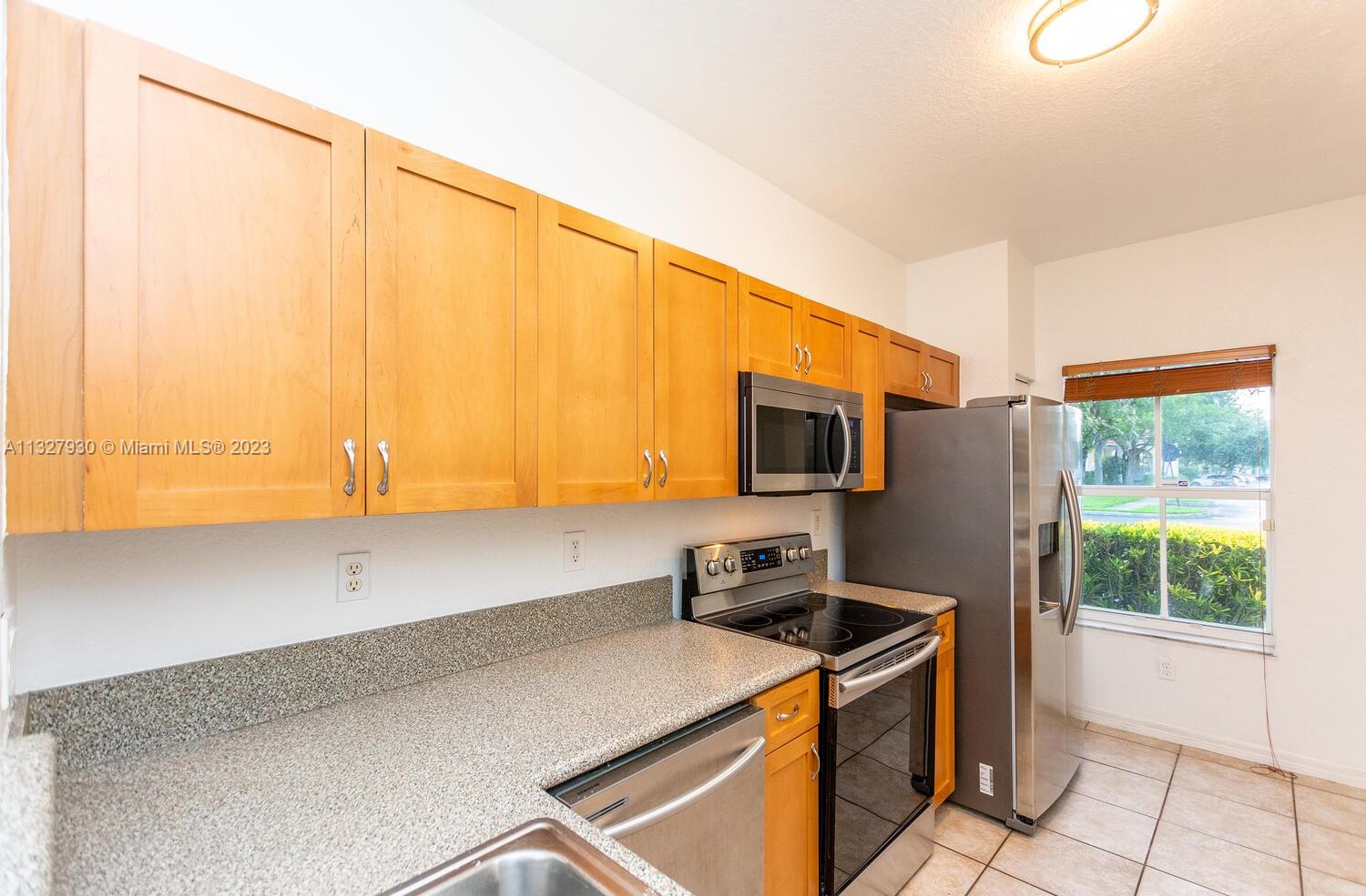 4979 Southwest 140th Terrace, Unit 8 Miramar, FL 33027 - Photo 19 of 43 a kitchen that has a microwave and a sink