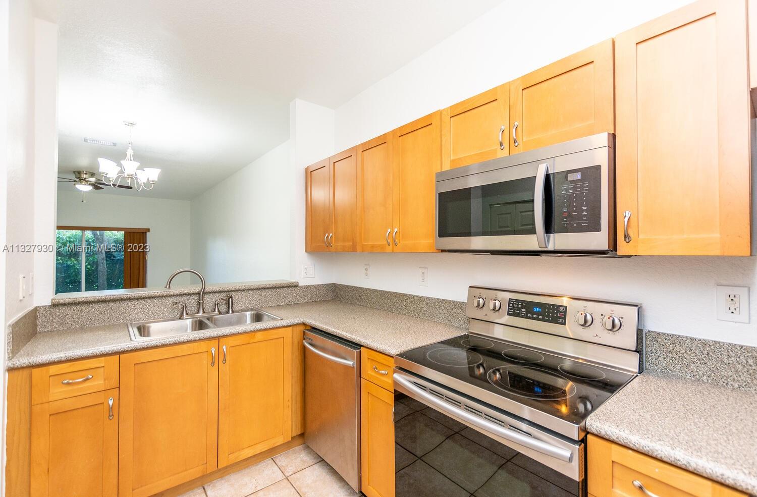 4979 Southwest 140th Terrace, Unit 8 Miramar, FL 33027 - Photo 22 of 43 a kitchen with a sink and a microwave