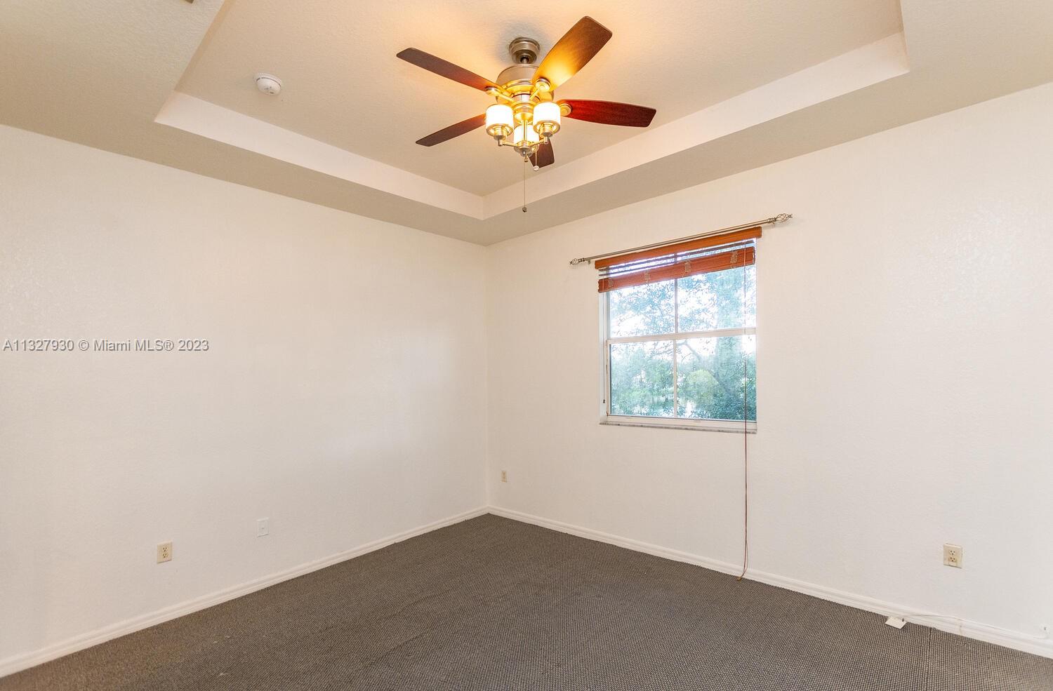 4979 Southwest 140th Terrace, Unit 8 Miramar, FL 33027 - Photo 24 of 43 an empty room with windows and fan