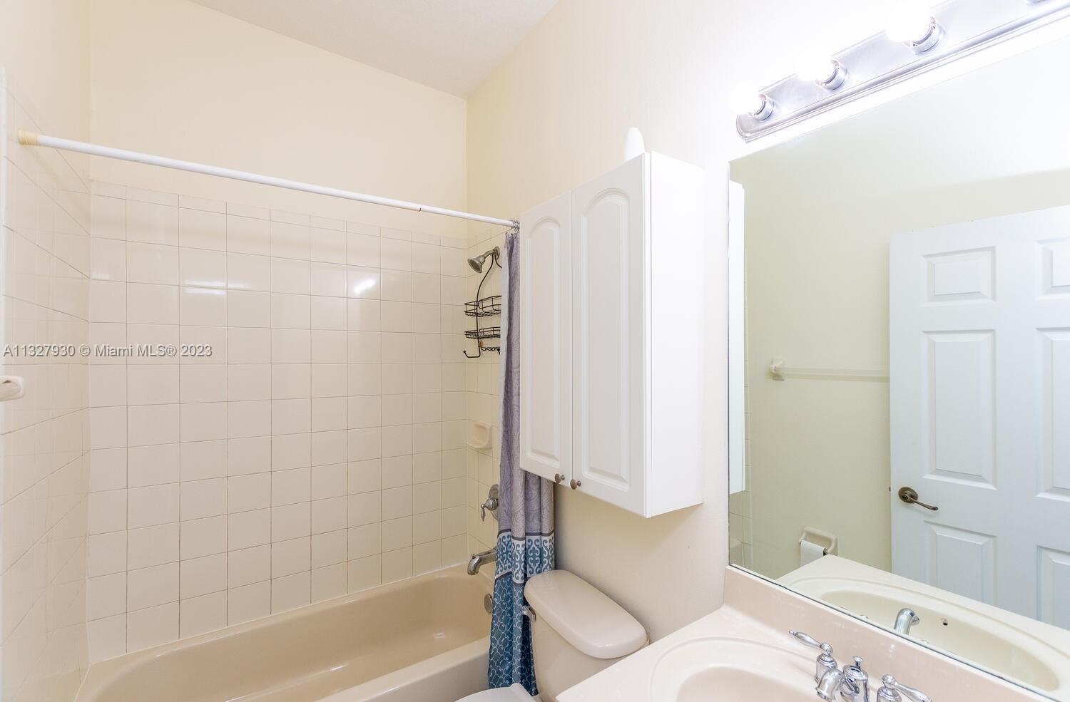 4979 Southwest 140th Terrace, Unit 8 Miramar, FL 33027 - Photo 27 of 43 a bathroom with a bathtub and a shower