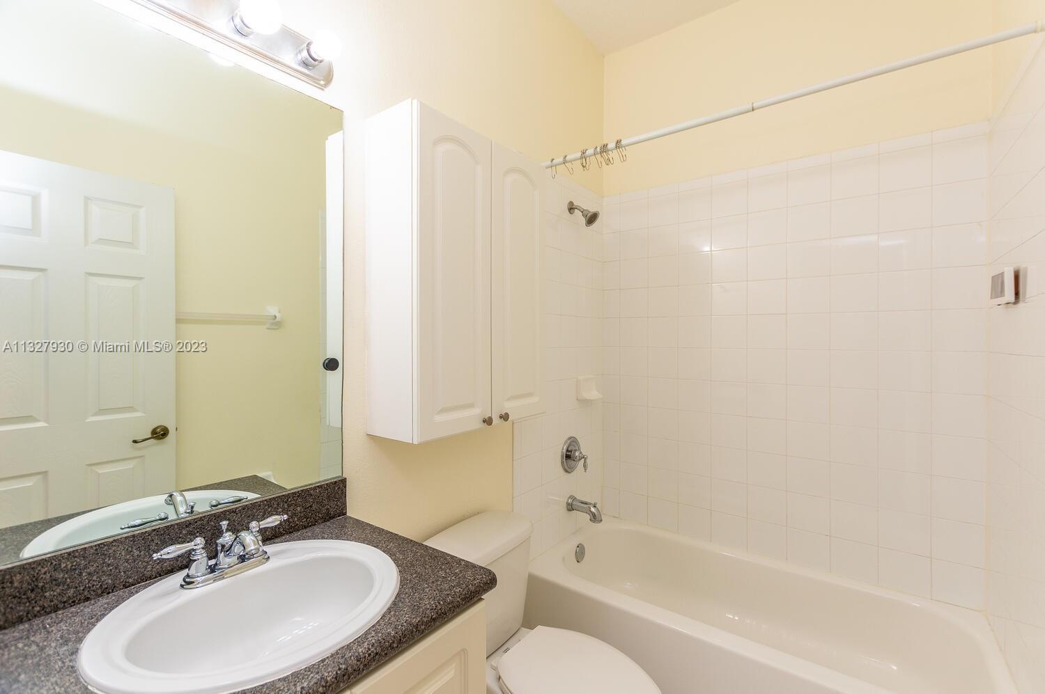 4979 Southwest 140th Terrace, Unit 8 Miramar, FL 33027 - Photo 32 of 43 a bathroom with a granite countertop sink toilet and shower