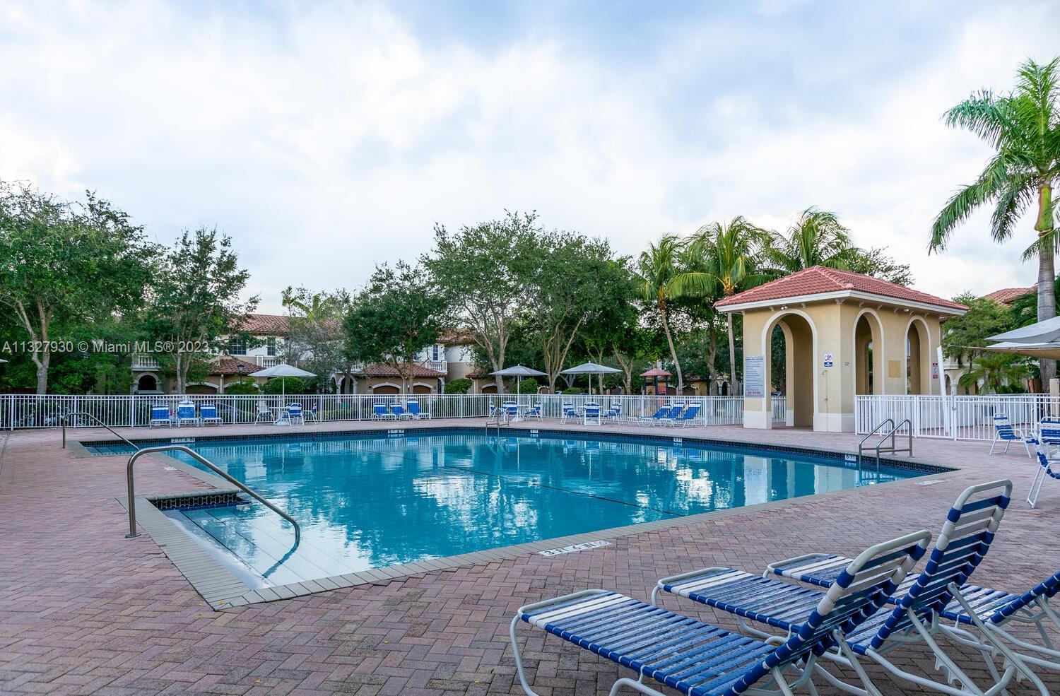 4979 Southwest 140th Terrace, Unit 8 Miramar, FL 33027 - Photo 36 of 43 a view of a swimming pool with a patio