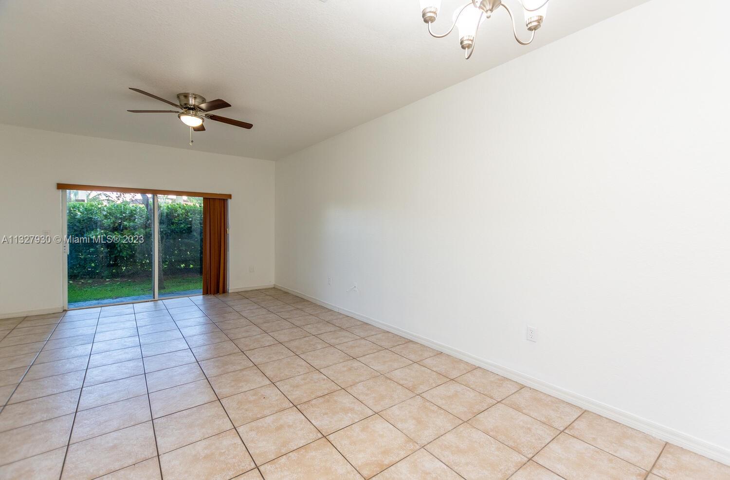 4979 Southwest 140th Terrace, Unit 8 Miramar, FL 33027 - Photo 7 of 43 a view of an empty room with windows