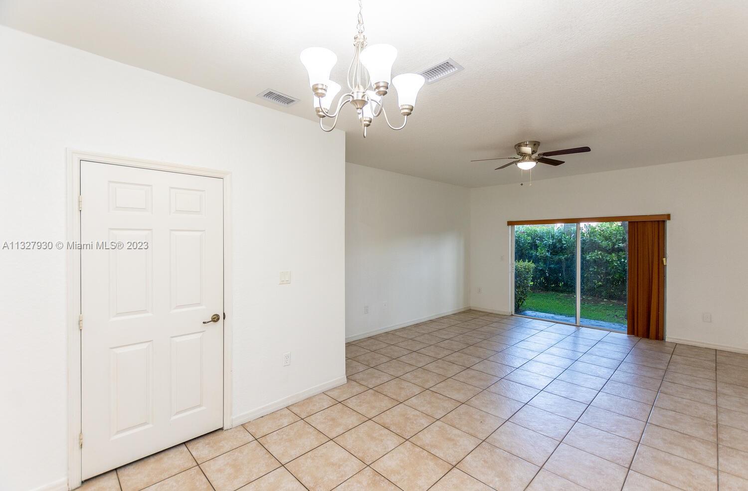 4979 Southwest 140th Terrace, Unit 8 Miramar, FL 33027 - Photo 8 of 43 a view of an empty room with a window